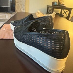 Miu Miu black perforated leather platform slip on sneakers.